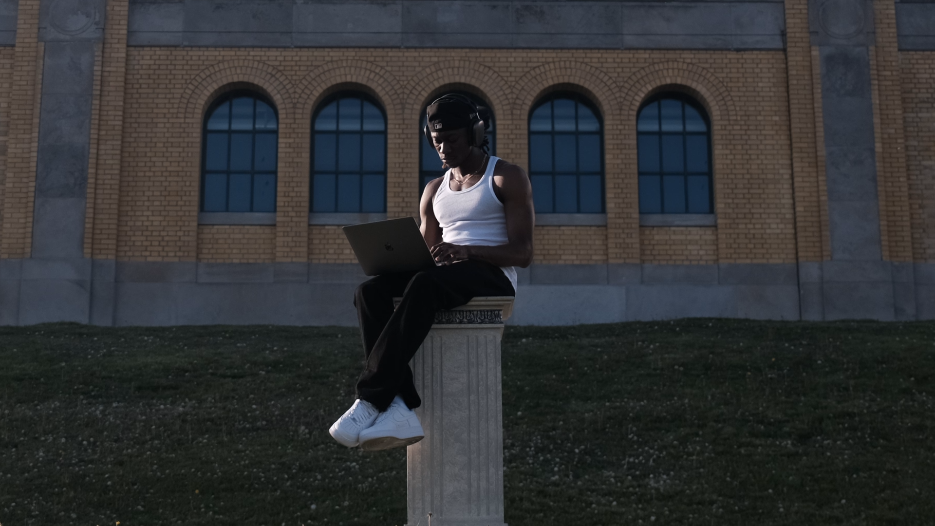 Isaiah Peck is sitting on a roman column using StageKeep to plan formations for his dance performance